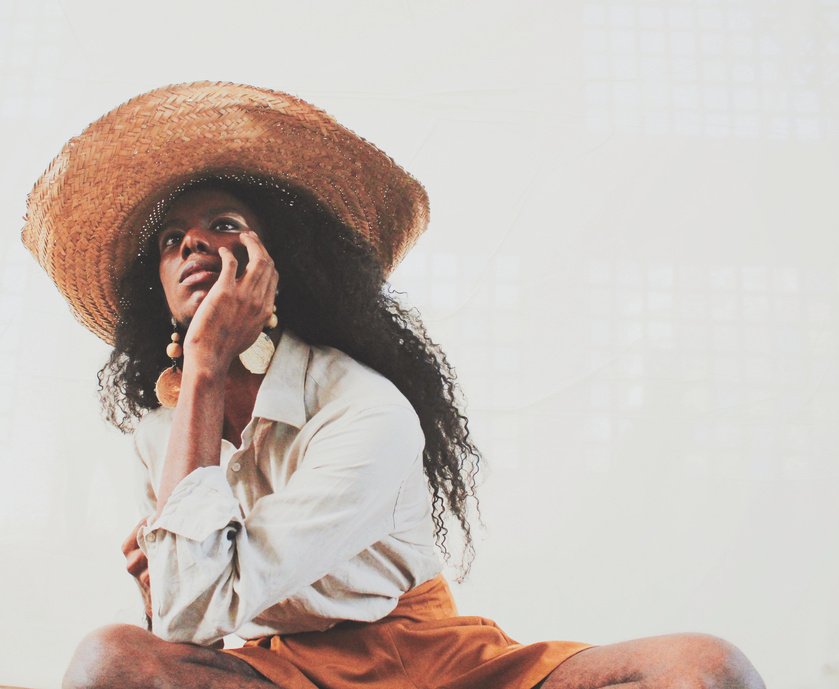 Stylish dreamy African woman on white background