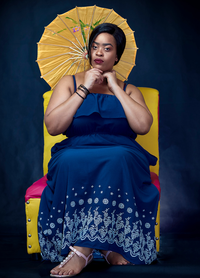 Woman Wearing Blue and White Floral Dress Holding Yellow Japanese Umbrella