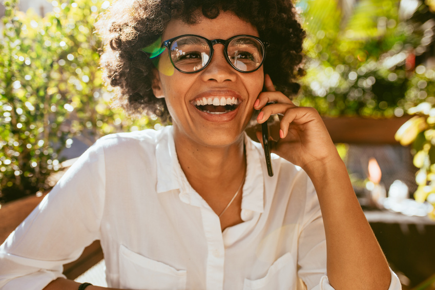 Woman Having a Conversation on Phone at Cafe