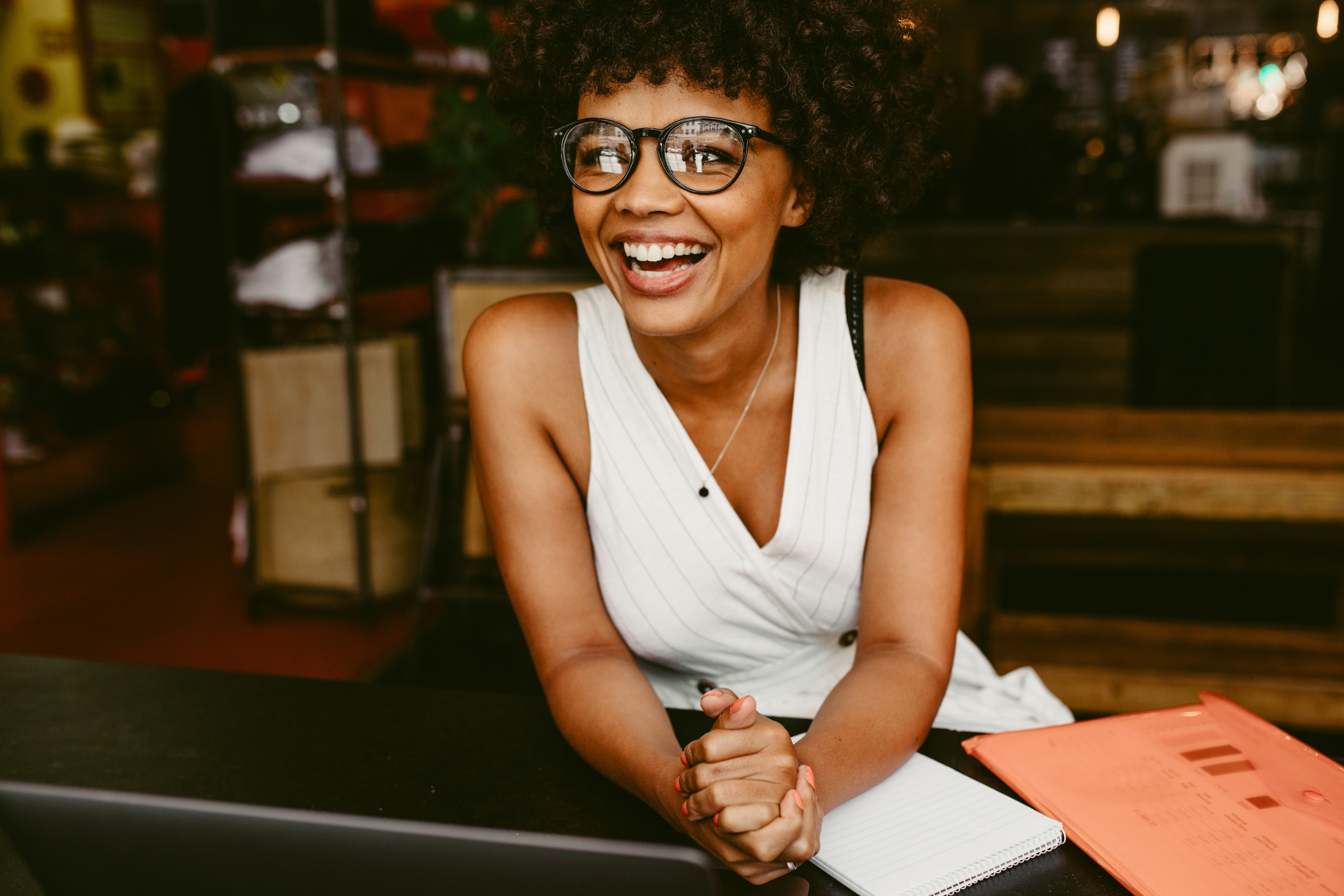 Smiling Woman Sitting in the Cafe